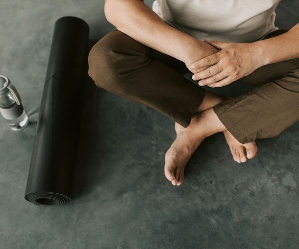 Yoga mats, water bottles, and comfortable clothing laid out ready for a class.